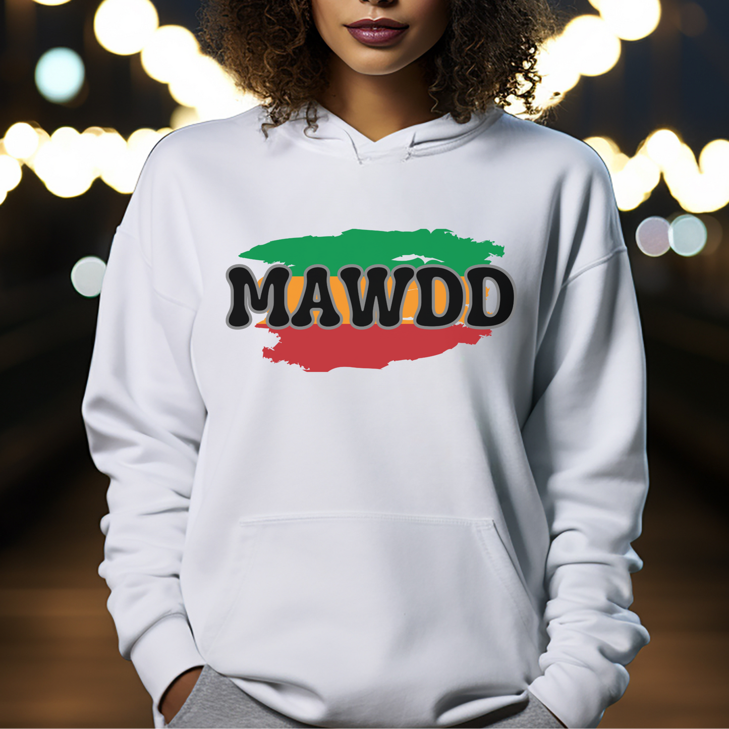 Person wearing a white hoodie with 'MAWDD' design against a blurred lights background
