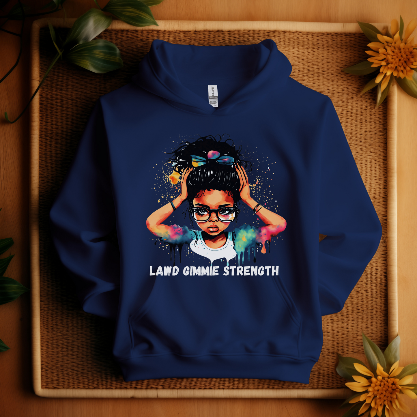 Blue hoodie with a graphic of a woman and text 'Lawd Gimme Strength' on a woven mat background.
