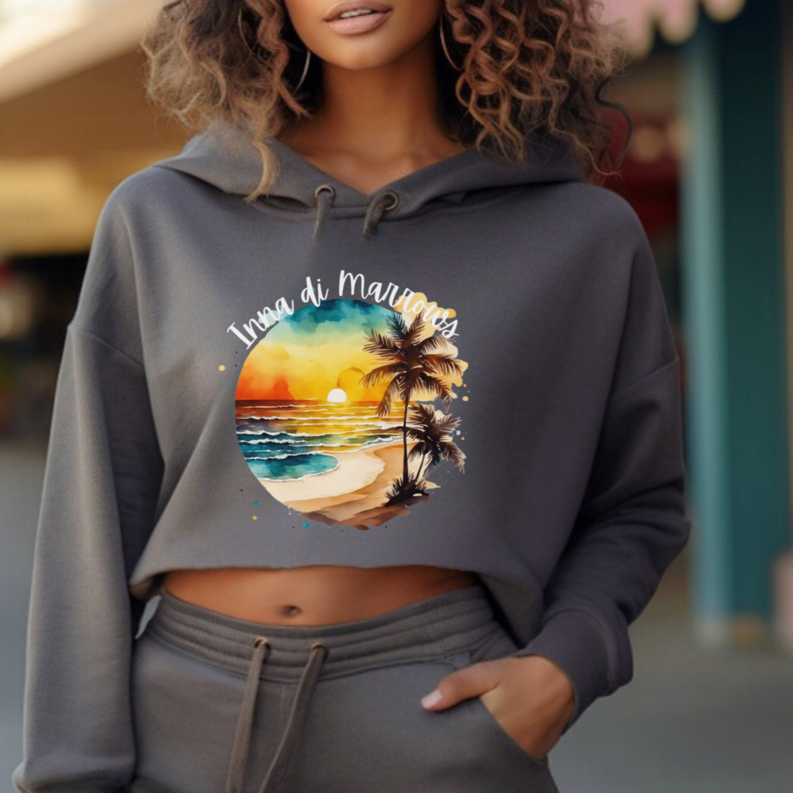 Woman wearing a gray hoodie with a graphic design on a city street